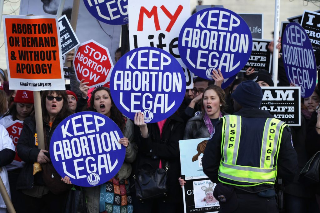 WASHINGTON, DC - JANUARY 22: Pro-choice activists shout slogans before the annual March for Life passes by the U.S. Supreme Court January 22, 2015 in Washington, DC. Pro-life activists gathered in the nation's capital to mark the 1973 Supreme Court Roe v. Wade decision that legalized abortion. (Photo by Alex Wong/Getty Images) ORG XMIT: 533840441